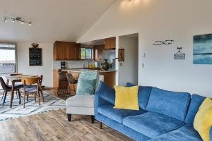 a living room with a blue couch and a kitchen at The Windbnb Overlook in Freeland