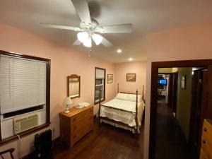 a bedroom with a bed and a ceiling fan at Little Haven in Highlands