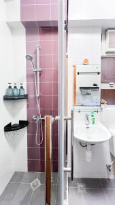a bathroom with a sink and a shower at Shared Apartment Lockhart Road 384 in Hong Kong