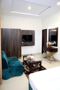 a living room with a blue chair and a table at Royalton Inn Hotel - Gulberg in Lahore