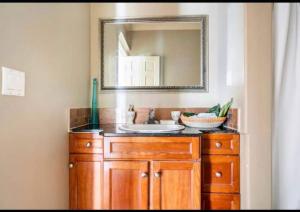 a bathroom with a sink and a mirror at Royal highland livingroom bedroom suite in Calgary