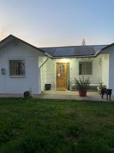 a house with a dog standing in front of it at Casa de Campo in Santa Cruz