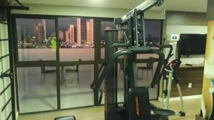 a room with a gym with a view of a city at Maravilhoso Home Service(510)prox Shopping Partage in Campina Grande