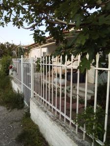 a white fence in front of a house at Marathon agios panteleimon attiki Greece in Panayía Mesosporítissa