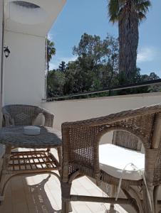 eine Terrasse mit 2 Korbstühlen und einem Tisch in der Unterkunft A casa di Gio in Lecce