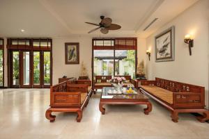 a large living room with couches and a ceiling fan at Daisy Beachfront Near Downtown Da Nang in Danang