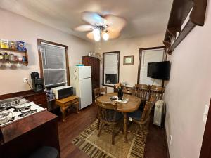 a kitchen with a table and a kitchen with a refrigerator at Little Haven in Highlands