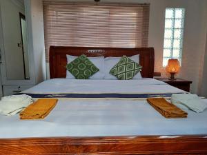 a bedroom with a large bed with two towels on it at Nary Apartment in Siem Reap
