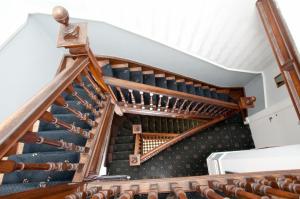a spiral staircase in a house with wooden railings at Garfield Guest House in Edinburgh