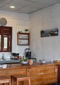 a kitchen with a wooden counter top in a room at Gray house up in Weligama