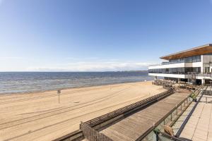 a view of a beach with a building and the ocean at BlydeHomes - Amazing Seaview! in Tallinn