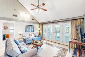 a living room with a couch and a ceiling fan at Knot Too Shabby in St. George Island