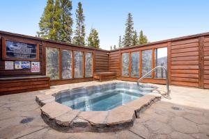 a house with a hot tub in a patio at Pine Ridge Condos in Breckenridge