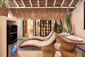 a living room with a couch and a table at Seminyak Beach Bungalow Studio Villa 1 with private pool SBB1 in Seminyak