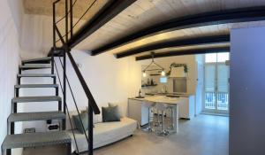 a living room with a staircase and a kitchen at Centrale56 in Bisceglie