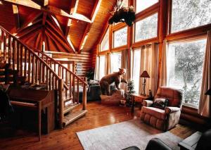 uma sala de estar com um urso de pé na janela em Happy Bear Lodge - Luxury 4 BR Cabin em Shasta Lake