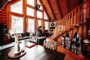 a living room with a couch and a staircase at The Happy Bear Lodge in Shasta Lake +58 photos