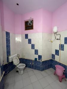 a bathroom with a toilet and a sink at Travel curiosity Homestay in Alwar