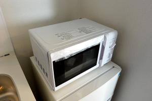 a microwave oven sitting on top of a dresser at オリエントシティ南堀江ⅡL in Osaka