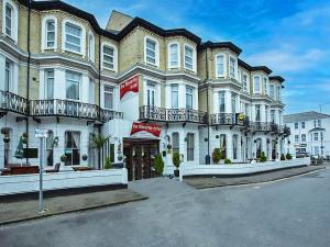 a large brick building with balconies on a street at The Waverley Hotel in Great Yarmouth +34 photos