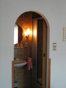 a bathroom with a sink and a mirror at Pension Alpentraum in Zell am See