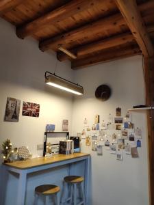 a kitchen with two stools and a wall with pictures on it at 芹壁小玖窩民宿 in Beigan