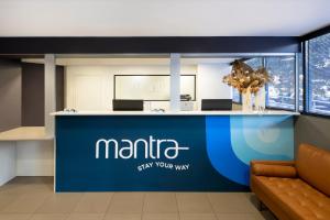 a lobby with a blue counter with the name maricistay your way at Mantra Castle Hill Sydney, an Accor Hotel in Castle Hill