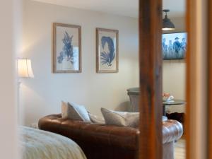 a living room with a brown leather couch at Cuillin Studio - Ukc6562 in Mallaig