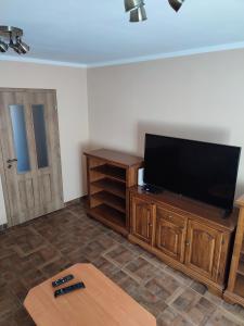 a living room with a flat screen tv on a wooden entertainment center at Apartmán Žilina in Žilina