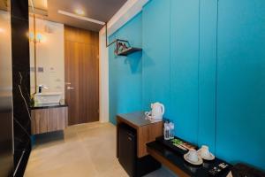 a bathroom with a blue wall and a sink at sunlight mound in Yuanshan