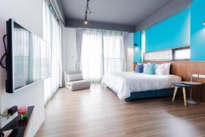 a bedroom with a large bed and a blue wall at sunlight mound in Yuanshan