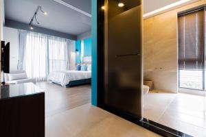 a room with a bedroom with a bed and a sliding door at sunlight mound in Yuanshan