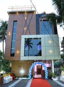 a building with a red carpet in front of it at Kurianplackal Residency in Alwaye