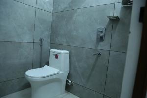 a bathroom with a toilet and a shower at Kurianplackal Residency in Alwaye