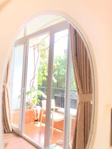 an arched mirror in a living room with an open window at Chez Lotus Rose in Ho Chi Minh City