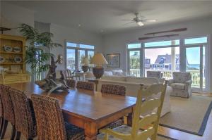 a living room with a dining room table and a couch at Nash Cottage home in Atlantic Beach +31 photos