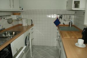 a kitchen with a sink and a counter top at Ferienhaus Nicole in Neuharlingersiel +2 photos