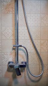 a shower head on a wall in a bathroom at Villa KiengKham晶康民宿 in Luang Prabang
