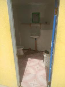 a small bathroom with a toilet and a sink at Hideaway Resort in Maraat