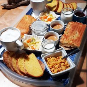 a tray filled with different types of bread and other foods at Come una volta in Monte Isola