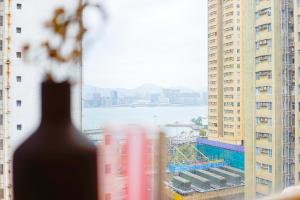 a view of a city from a window with buildings at Shared Room at Lockhart Road 414 in Hong Kong