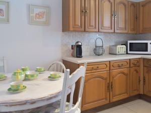 a kitchen with a table with cups and plates on it at Mousebank in Forth