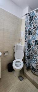 a bathroom with a toilet and a shower curtain at Apartament Andy in Saturn +12 photos