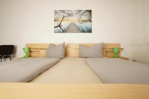 a bedroom with two beds and a picture on the wall at Havelschatz in Bensdorf