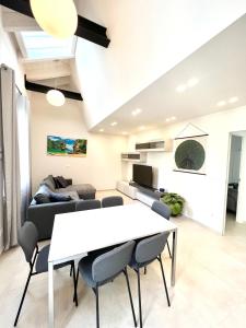 a living room with a white table and chairs at Tropicale in Rapallo