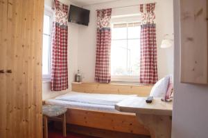 a bedroom with a bed and a window with curtains at Weißer Löwe in Burgthann