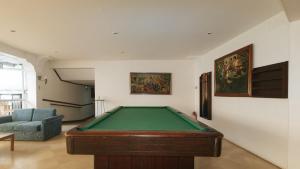 a living room with a pool table in it at Garden Plaza Hotel Manila in Manila