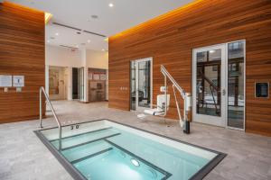 uma grande piscina num quarto com paredes de madeira em S Loop 1BR w Pool Gym Roof 1 block to L CHI-431 em Chicago