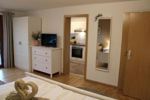 a room with a bedroom with a kitchen and a mirror at Ferienhaus Carl in Schluchsee