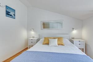 a bedroom with a large white bed with two night stands at Apartments Birimac in Pula +83 photos